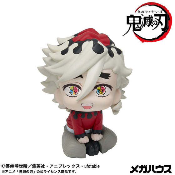 Anime character figurine with red and black outfit on a white background