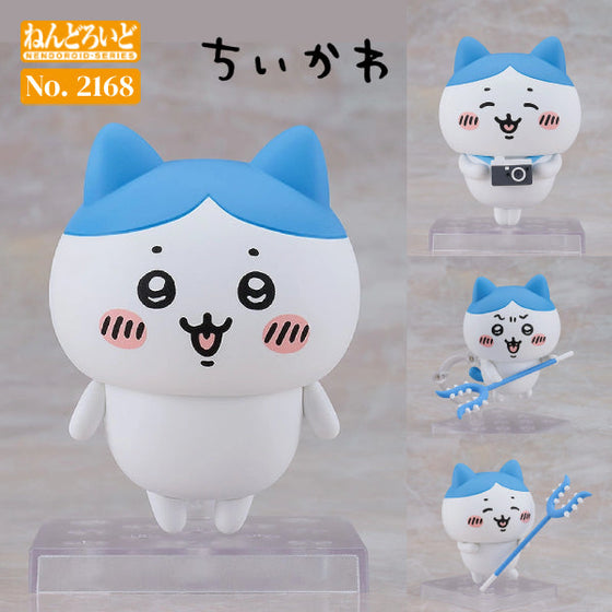 A Nendoroid figure of Hachiware from the series Chiikawa, featuring a smiling character with blue ears and eyes closed, holding a camera and presented in various poses.